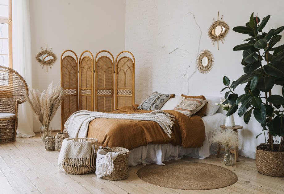 A bed with brown blanket and wicker baskets in a room