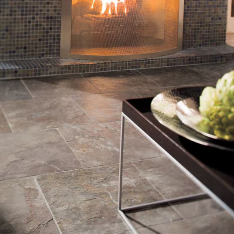 gray stone flooring in front of a fireplace